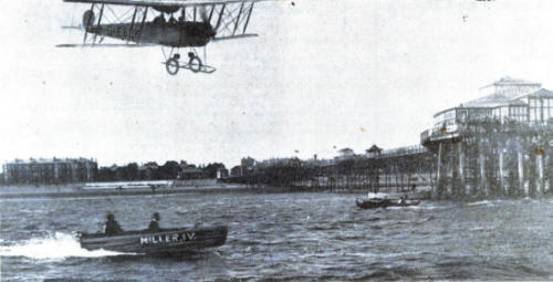 An aeroplane, from the Lancashire School of Aviation at Squires Gate, flying over Lytham Pier in 1930.