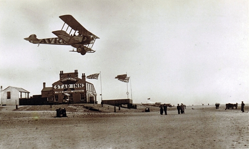 An AVRO Aircraft flying over the Star Inn, South Shore, Blackpool, 1919.