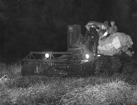 Two photos of harvesting by floodlight, Peel Hall Farm 1956.
