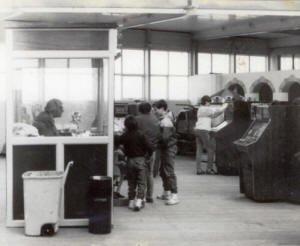 'Wilf' in his change kiosk, the Amusement Arcade, St.Annes Pier, in the early 1980s.